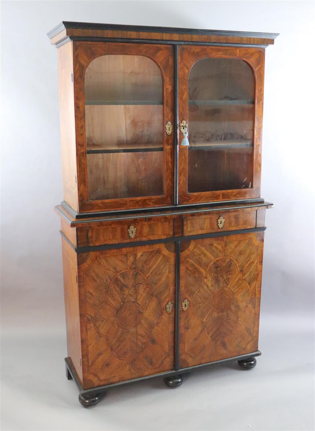 An 18th century Dutch walnut, olivewood and ebony bookcase, W.4ft 2in. D.1ft 5.5in. H.7ft